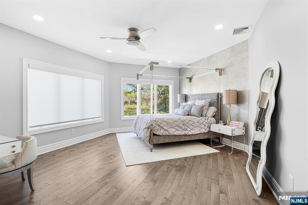 817 West Shore Drive Butler, NJ 07405 - Photo 27 of 50 a bedroom with a bed wooden floor and a large window