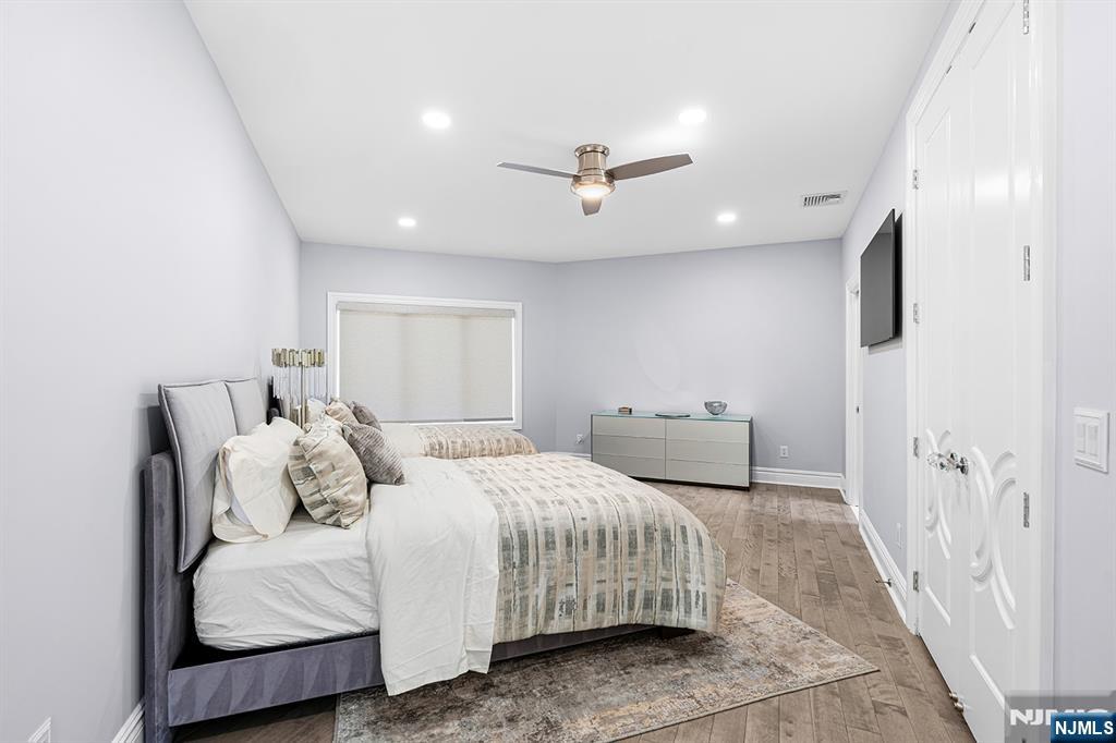 817 West Shore Drive Butler, NJ 07405 - Photo 28 of 50 a bedroom with a bed and a flat screen tv