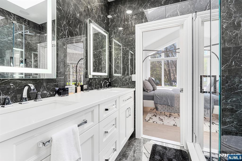 817 West Shore Drive Butler, NJ 07405 - Photo 31 of 50 a en suite bathroom with a double vanity sink and a mirror