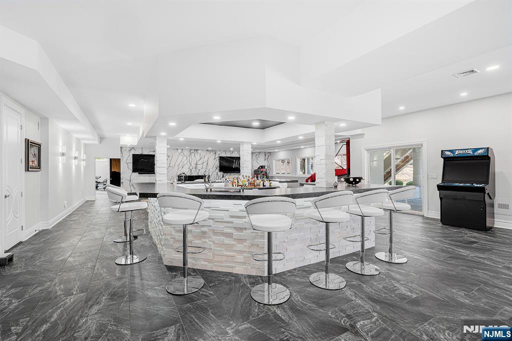 817 West Shore Drive Butler, NJ 07405 - Photo 34 of 50 a large white kitchen with kitchen island a table and chairs in it