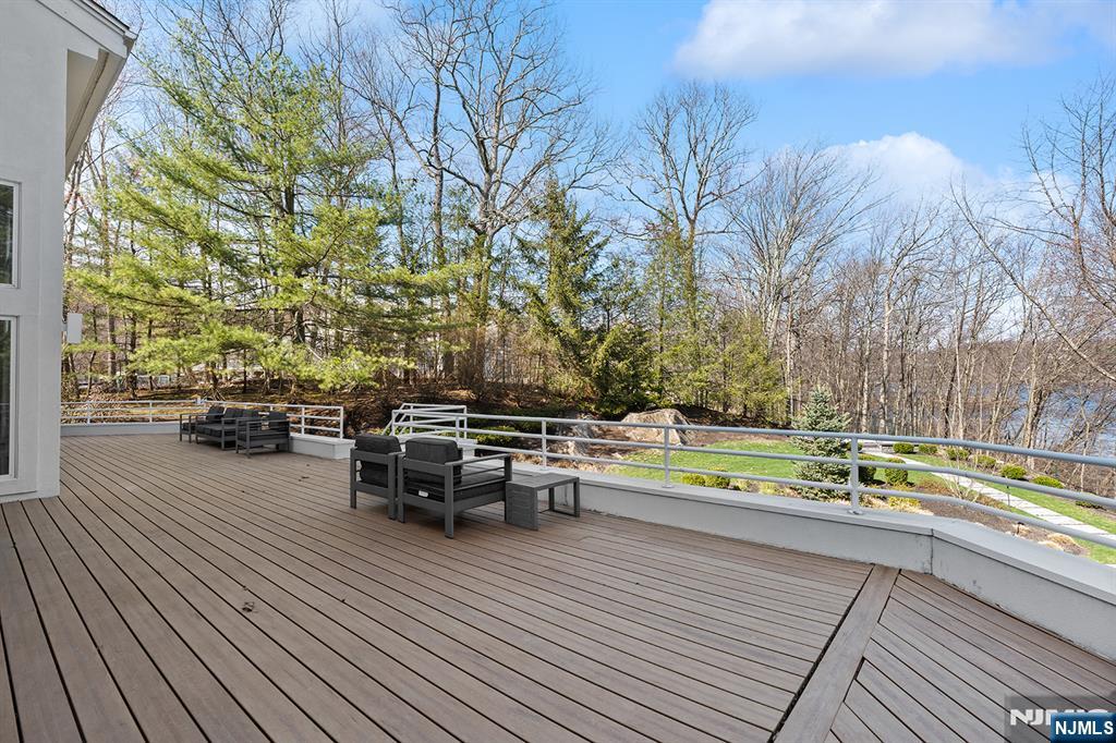 817 West Shore Drive Butler, NJ 07405 - Photo 40 of 50 a view of a patio with dining table and chairs with wooden floor and fence