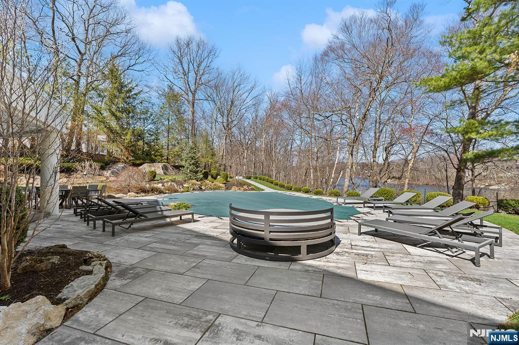 817 West Shore Drive Butler, NJ 07405 - Photo 42 of 50 a backyard of a house with barbeque oven and trees