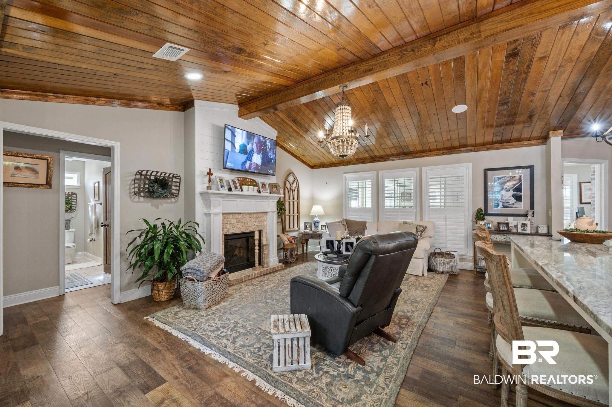 38211-d) V R Byrd Road Bay Minette, AL 36507 - Photo 5 of 58 Living room with wooden ceiling, vaulted ceiling with beams, dark hardwood / wood-style flooring, a notable chandelier, and a fireplace