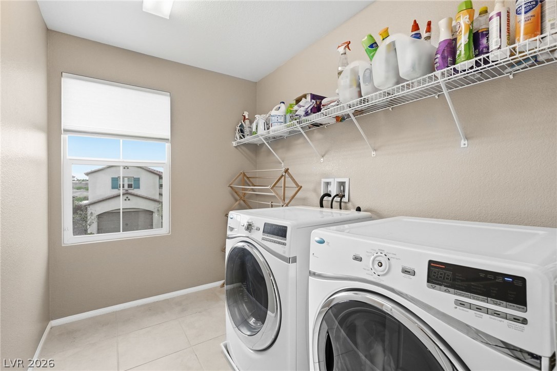 150 Fulgora Street Henderson, NV 89074 - Photo 39 of 92 Laundry area featuring washing machine and clothes dryer and light tile patterned floors