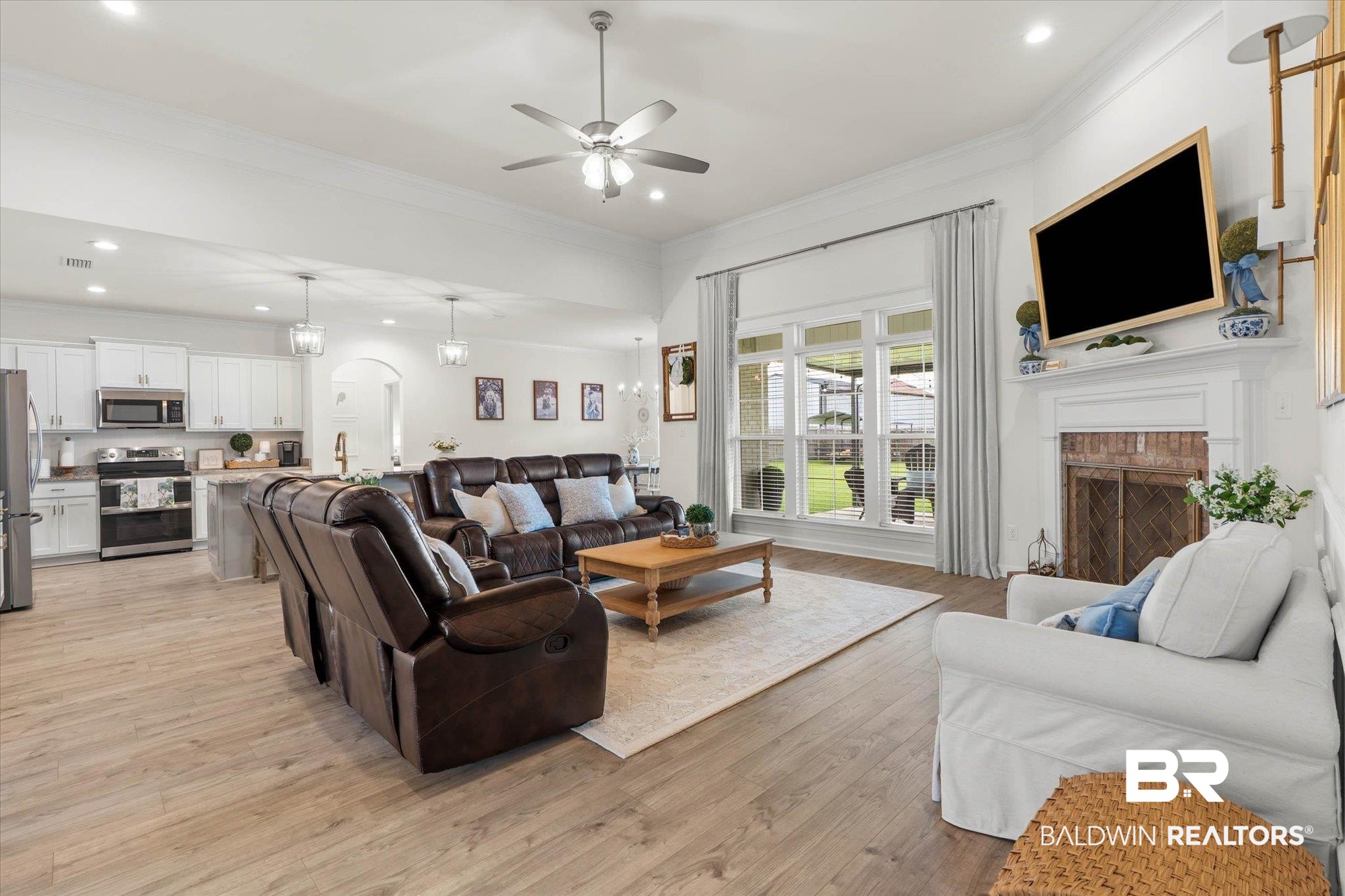 9074 Moses Way Theodore, AL 36582 - Photo 15 of 52 Spacious living area featuring high vaulted ceilings, recessed lighting, and wood-finish flooring
