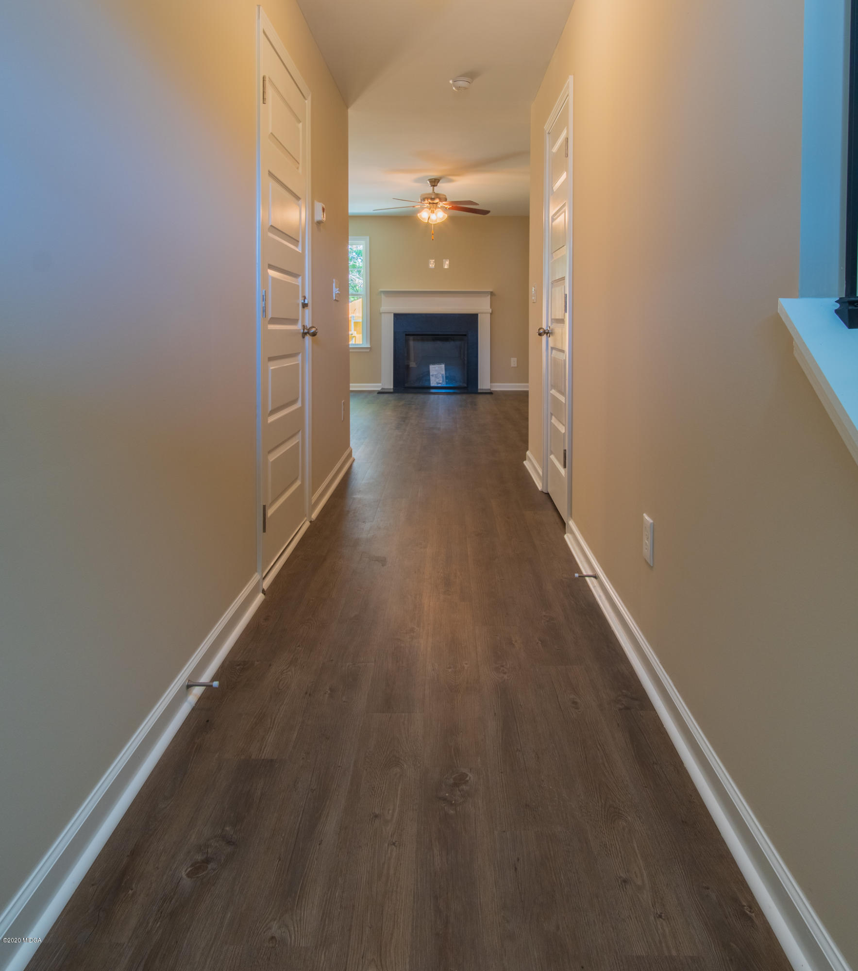 303 Pond View Road Macon, GA 31206 - Photo 20 of 33 wooden floor in an empty room with a fireplace