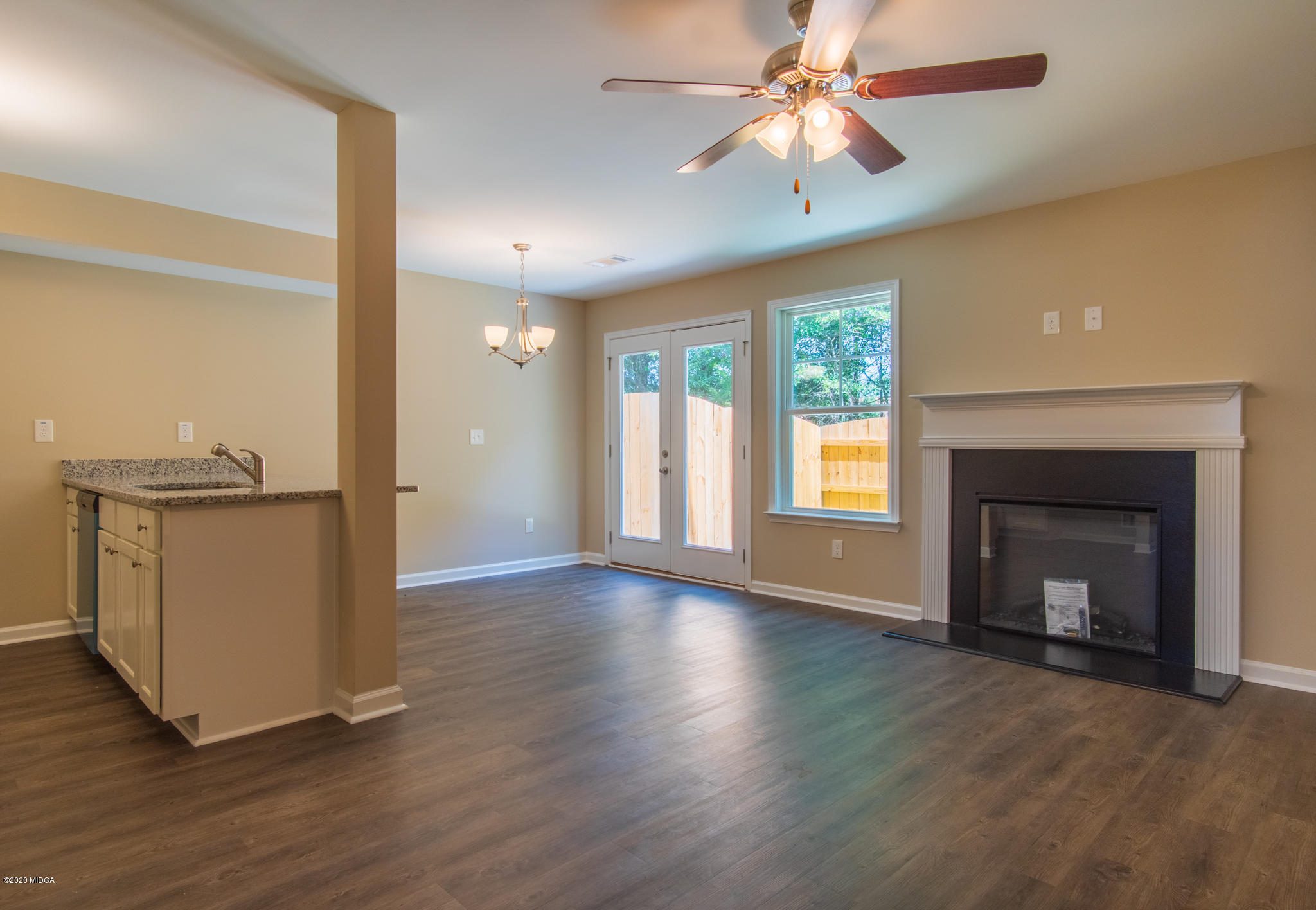 303 Pond View Road Macon, GA 31206 - Photo 5 of 33 wooden floor fireplace and windows in an empty room