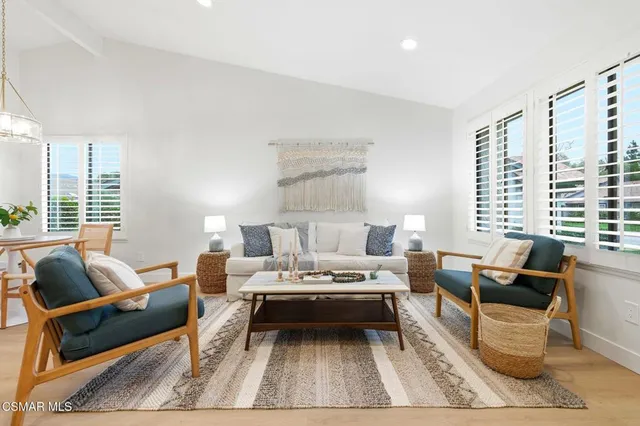 a living room with furniture or couch and a large window