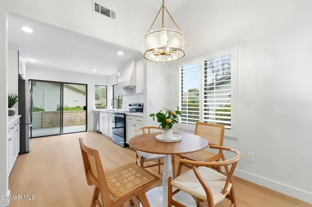 a view of a dining room with furniture and chandelier