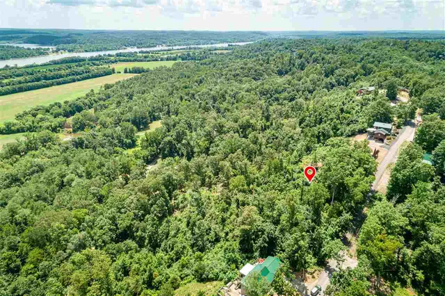 a backyard of a house with a yard and outdoor seating