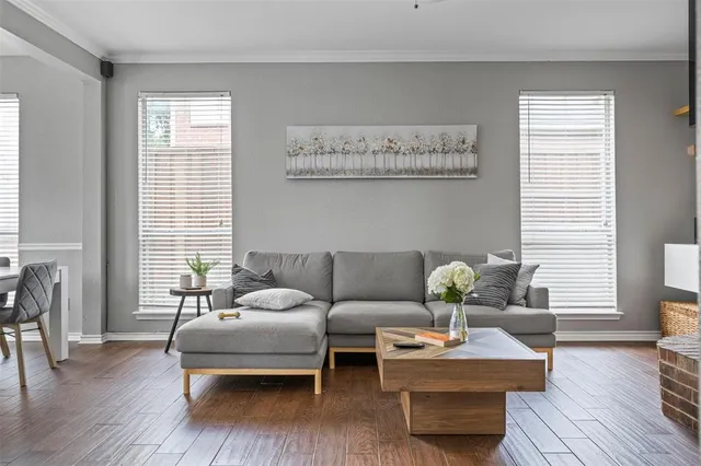 a living room with furniture and wooden floor