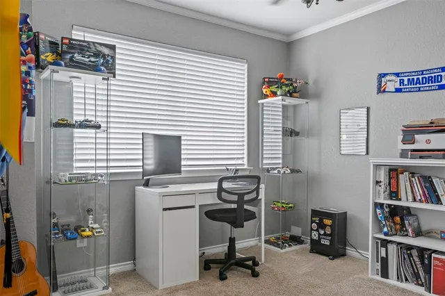 a view of a workspace with furniture and a window