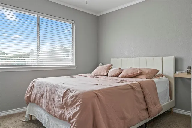 a bedroom with a bed and window
