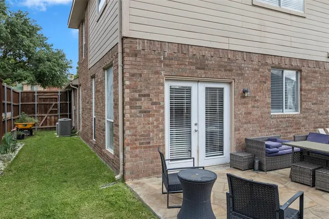 a view of a patio with chair and tables back yard of the house