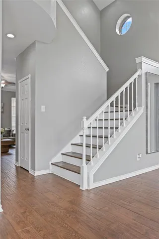 a view of entryway and hall with wooden floor