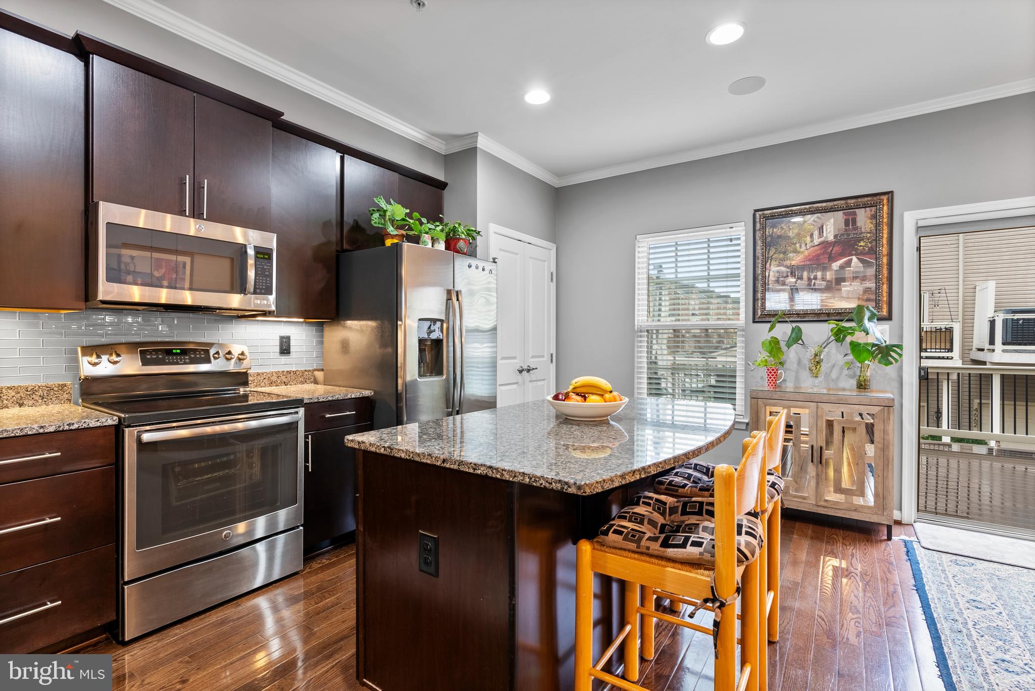 834 Oldham Street Baltimore, MD 21224 - Photo 13 of 55 a kitchen with stainless steel appliances a stove refrigerator sink and microwave