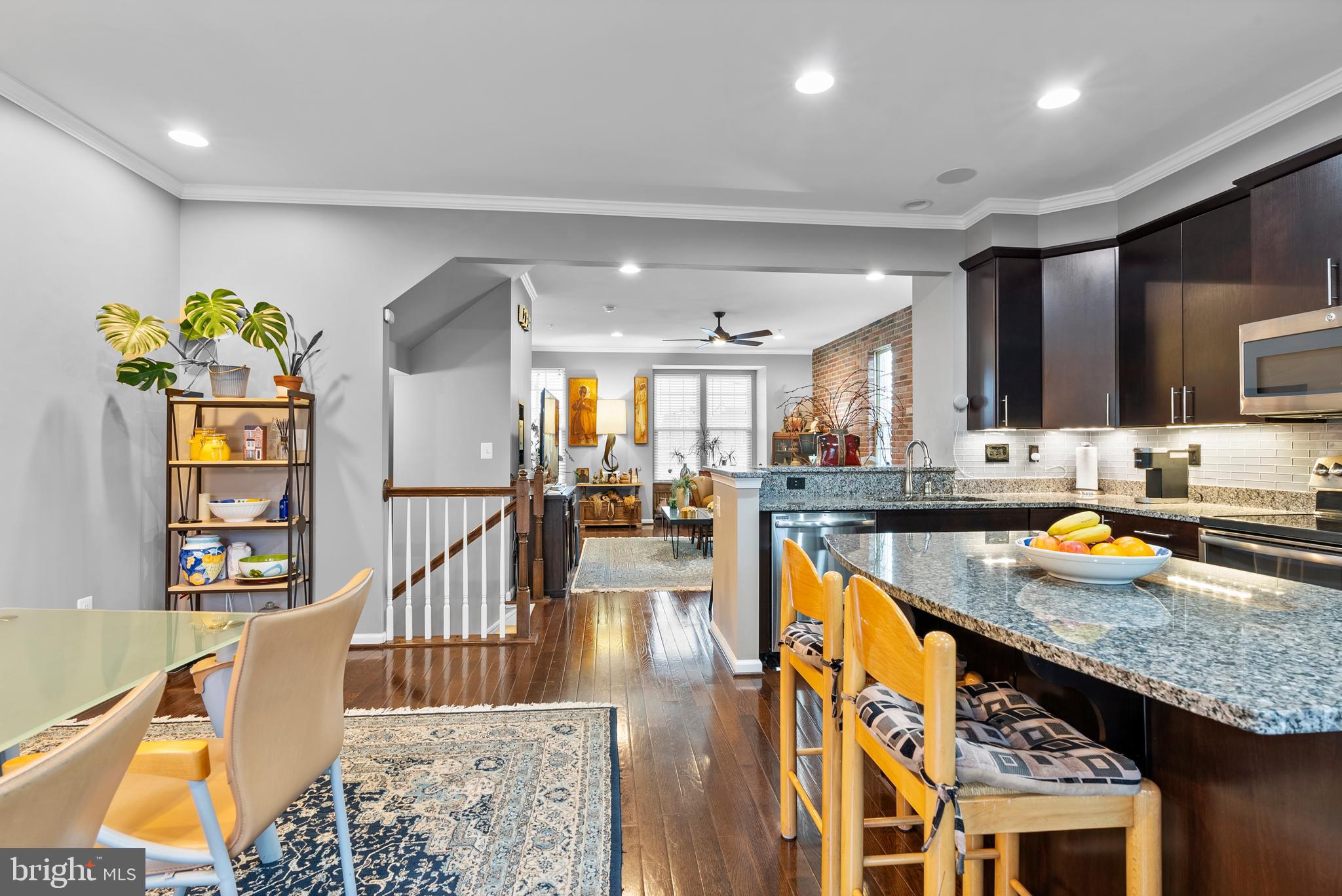 834 Oldham Street Baltimore, MD 21224 - Photo 16 of 55 a kitchen with stainless steel appliances granite countertop a sink a stove and a wooden floors