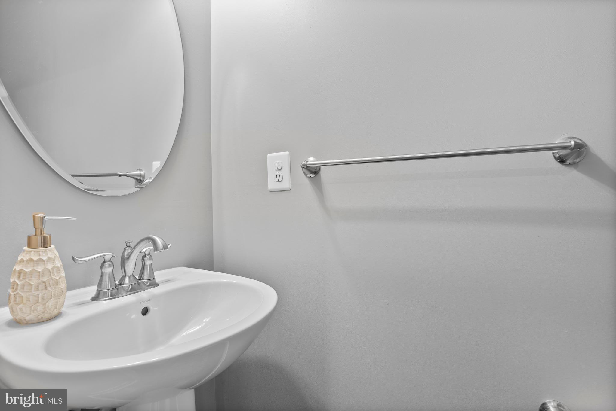 834 Oldham Street Baltimore, MD 21224 - Photo 29 of 55 a bathroom with a sink and a mirror