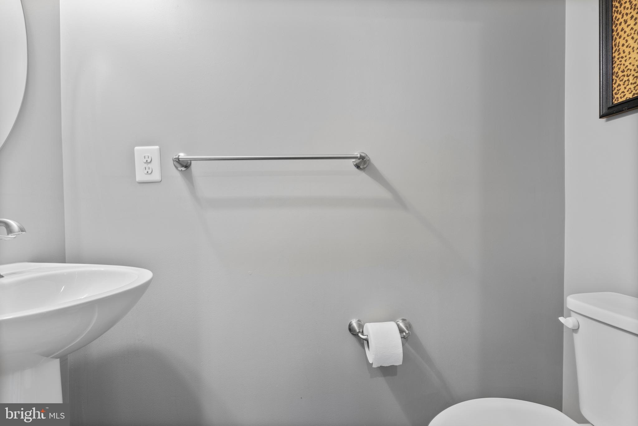 834 Oldham Street Baltimore, MD 21224 - Photo 30 of 55 a white toilet sitting next to a bathroom sink