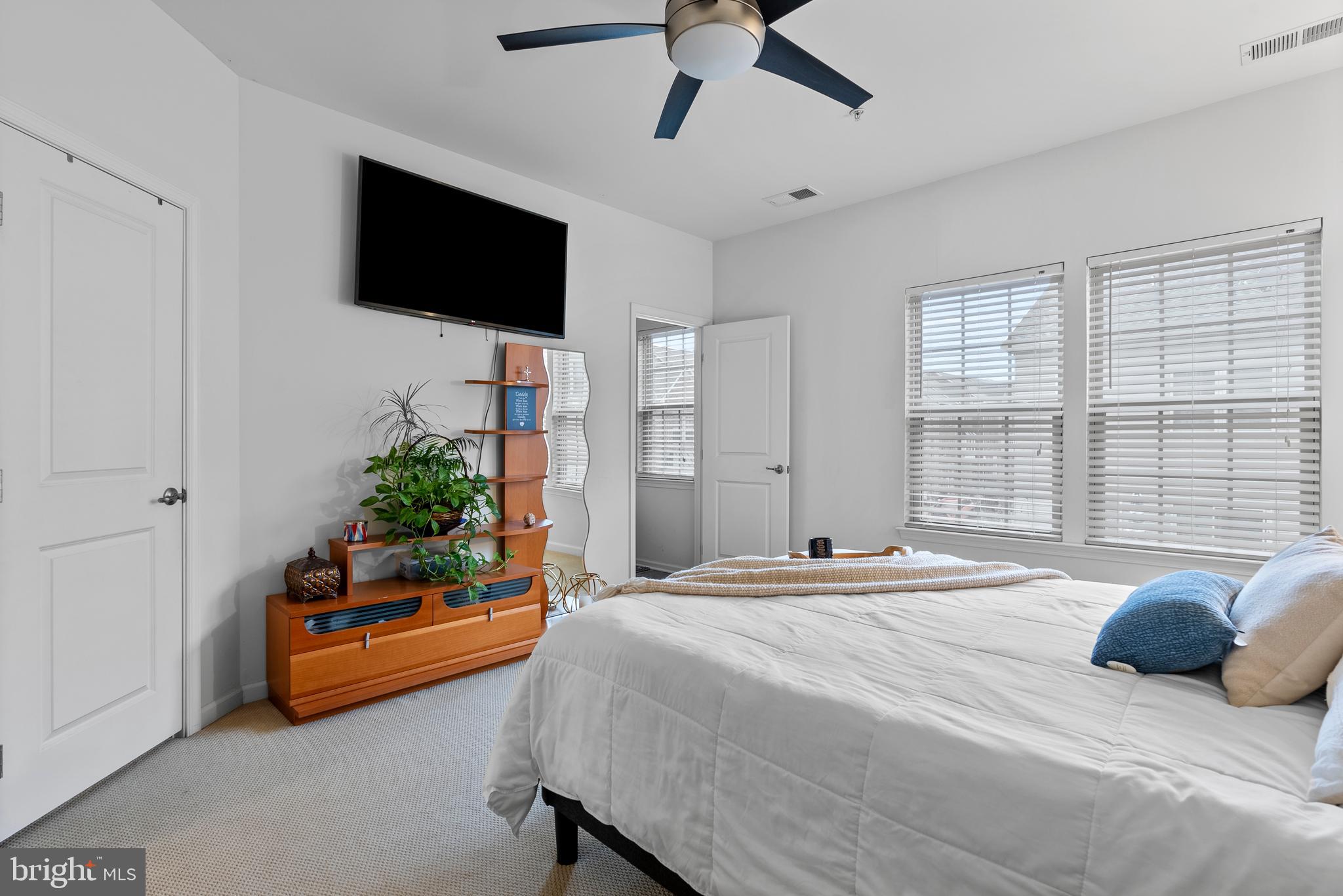 834 Oldham Street Baltimore, MD 21224 - Photo 33 of 55 a bedroom with a bed a flat screen tv and a window