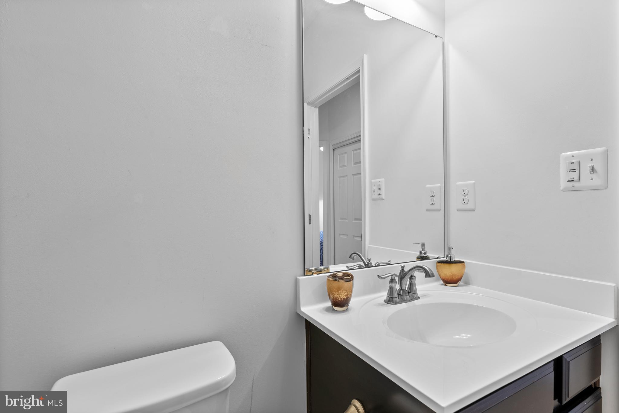 834 Oldham Street Baltimore, MD 21224 - Photo 41 of 55 a bathroom with a sink a toilet and mirror