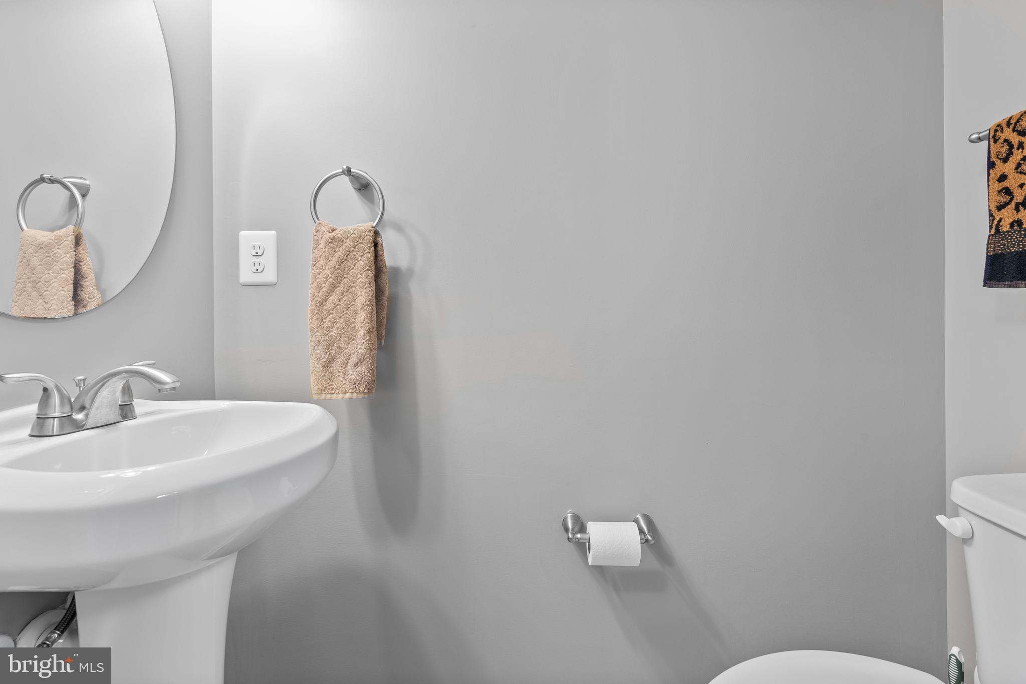 834 Oldham Street Baltimore, MD 21224 - Photo 9 of 55 a bathroom with a toilet sink and mirror