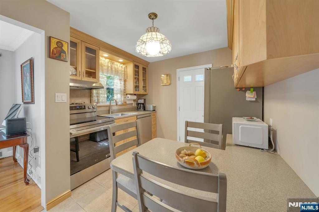 24 Cambridge Road Tenafly, NJ 07670 - Photo 15 of 31 a kitchen with a refrigerator and a stove