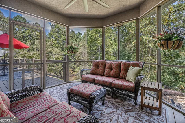a living room with furniture and a floor to ceiling window