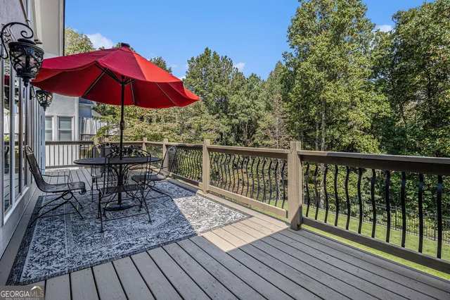a view of a chairs and table on the wooden deck