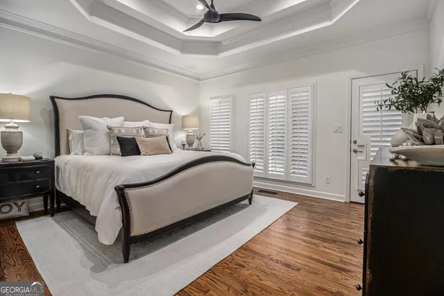 a bedroom with a large bed and a chandelier