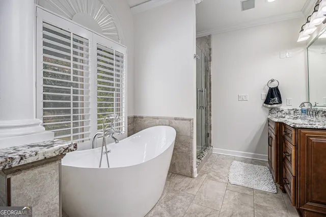 a spacious bathroom with a tub and a sink