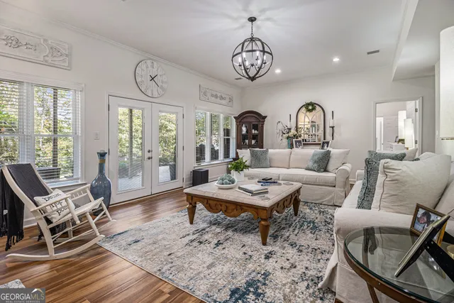 a living room with furniture a dining table and a large window