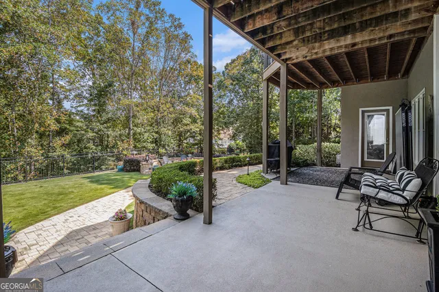 a view of a patio with chairs and a yard