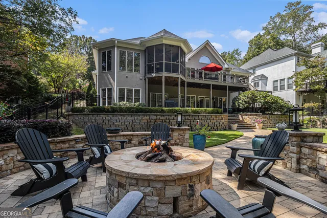a backyard of a house with fire pit and outdoor seating