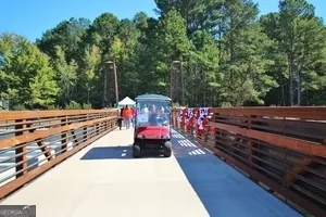 a view of swimming pool with outdoor seating and a garden