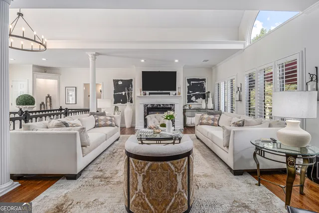 a living room with fireplace furniture and a flat screen tv