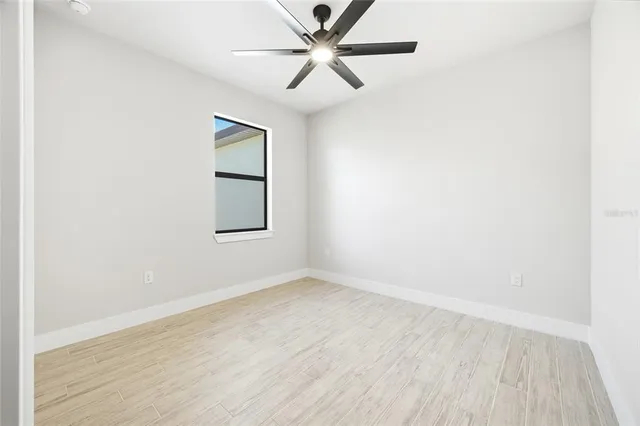 an empty room with a window and closet