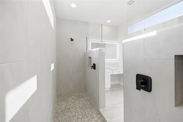 a bathroom with a shower and a glass door