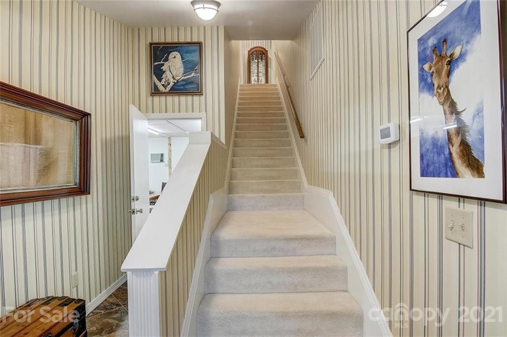 3271 Polk County Line Road Rutherfordton, NC 28139 - Photo 21 of 48 a view of staircase with lots of frames on wall and a large window