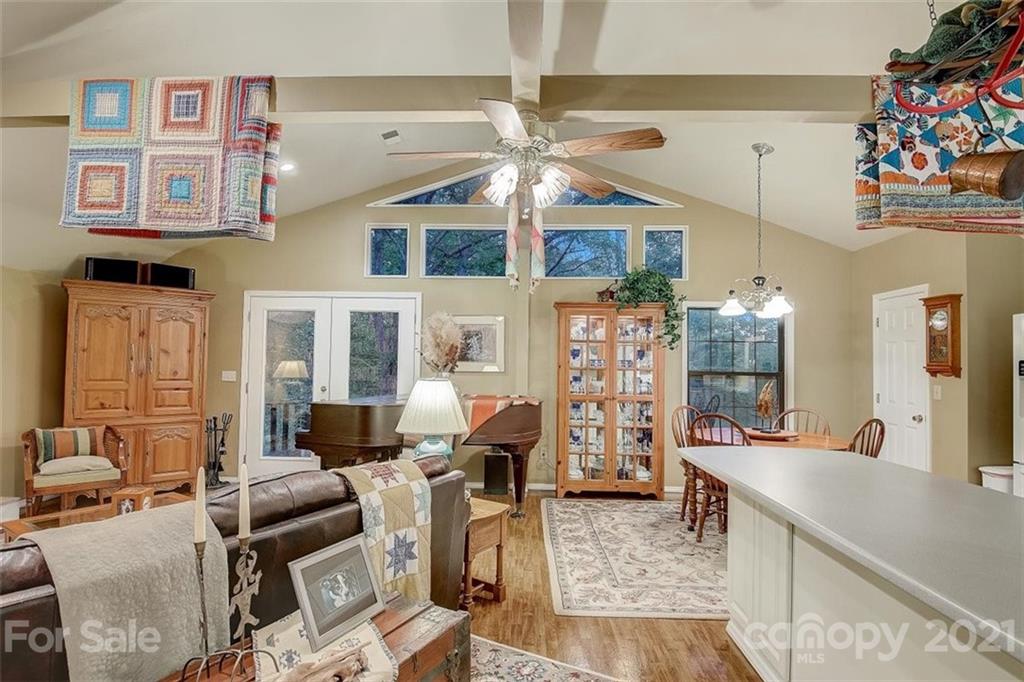 3271 Polk County Line Road Rutherfordton, NC 28139 - Photo 22 of 48 a living room with furniture a flat screen tv and a chandelier