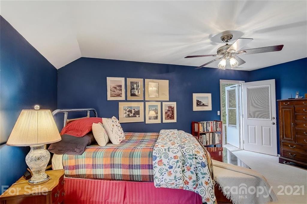 3271 Polk County Line Road Rutherfordton, NC 28139 - Photo 32 of 48 a bedroom with a bed and a chandelier