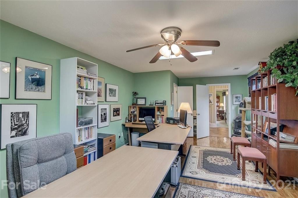 3271 Polk County Line Road Rutherfordton, NC 28139 - Photo 39 of 48 a living room with furniture a bookshelf and a chandelier