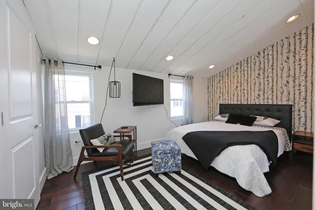 a bedroom with a bed and a view of balcony