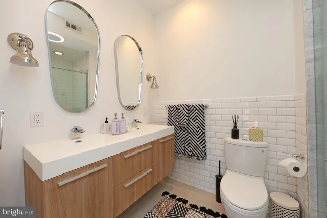 a bathroom with a toilet a sink and mirror