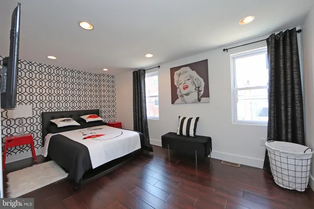 a bedroom with a bed and a television