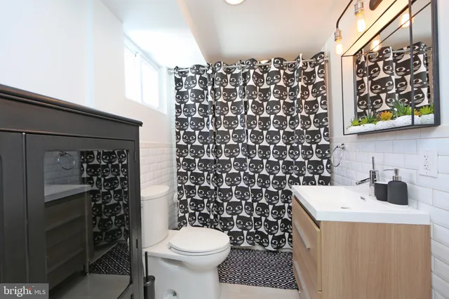 a bathroom with a granite countertop shower and a mirror