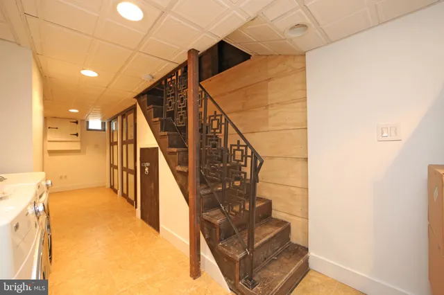a view of kitchen with sink and refrigerator