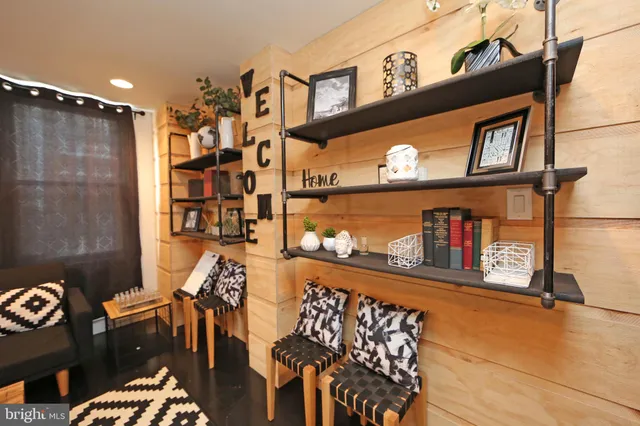 a living room with furniture a rug and a chandelier