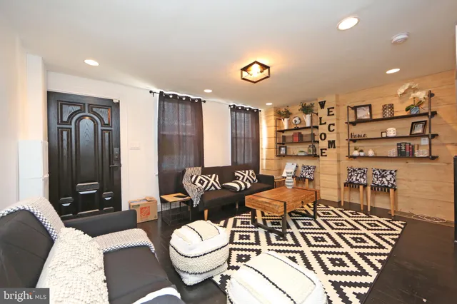 a living room with furniture and wooden floor