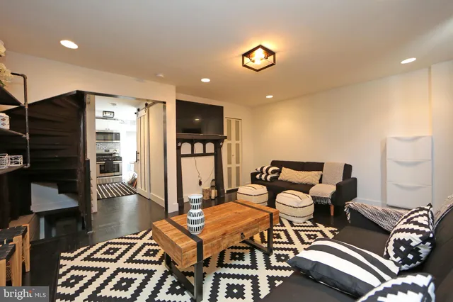 a living room with furniture a rug and a chandelier